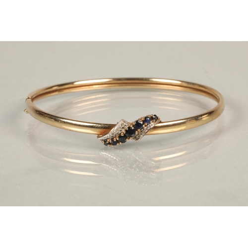 89 - 9 ct gold sapphire and diamond bangle, total weight 6.5 grams