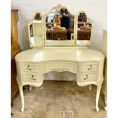 564 - Contemporary ornate bedroom suite to include dressing table with mirror, serpentine five-drawer ches... 