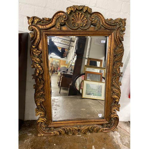 551 - Large mirror in ornate giltwood frame, 89cm x 58.5cm (130cm x 90cm)