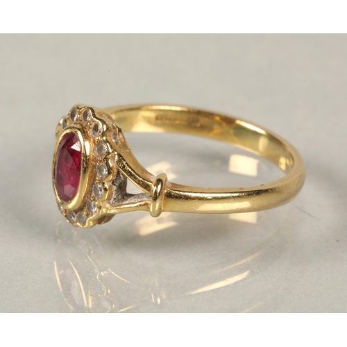 69 - 18 ct yellow gold ring with red central stone surrounded by diamonds