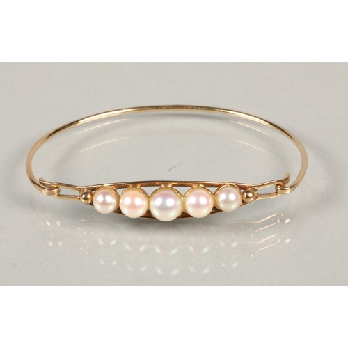 75 - 9 ct gold bangle , with row of pearls clasp.6.8 grams