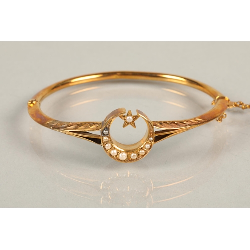 78 - 9 ct gold bangle with moon and star , with seed pearls, 5.6 grams total weight