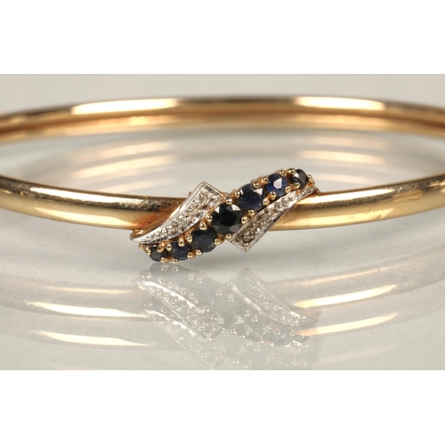 89 - 9 ct gold sapphire and diamond bangle, total weight 6.5 grams