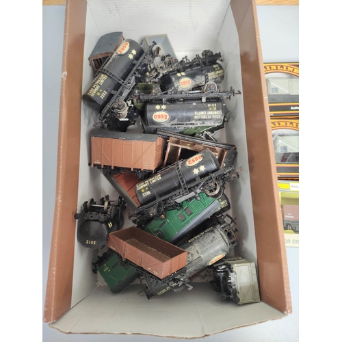 199 - Box containing a collection of 00 gauge rolling stock to include Esso tankers, covered wagons and ot... 