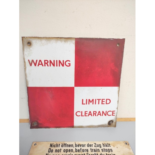 437 - An enamel red and white checkered warning limited clearance sign 30.5 x 30.5cm, and a European train... 