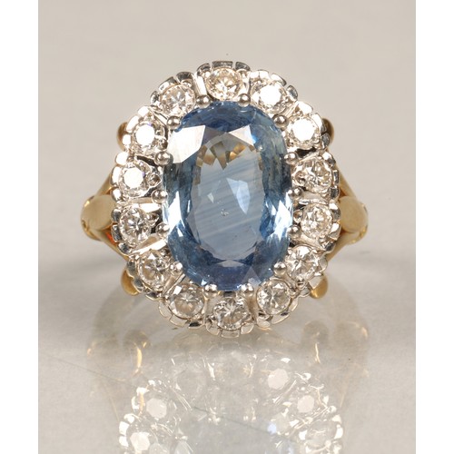 61 - Ladies blue topaz and diamond ring, Central stone surrounded by fourteen brilliant cut 0.1 carat dia... 