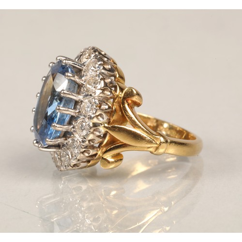 61 - Ladies blue topaz and diamond ring, Central stone surrounded by fourteen brilliant cut 0.1 carat dia... 