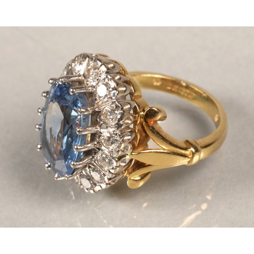 61 - Ladies blue topaz and diamond ring, Central stone surrounded by fourteen brilliant cut 0.1 carat dia... 