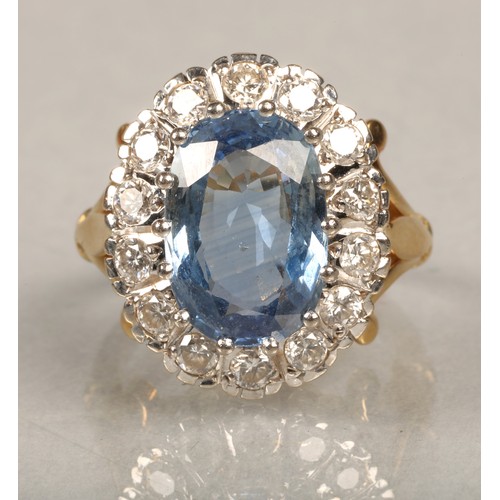 61 - Ladies blue topaz and diamond ring, Central stone surrounded by fourteen brilliant cut 0.1 carat dia... 