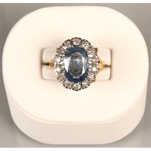 61 - Ladies blue topaz and diamond ring, Central stone surrounded by fourteen brilliant cut 0.1 carat dia... 