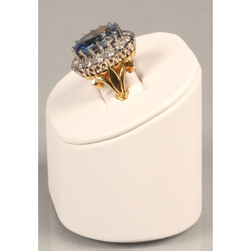 61 - Ladies blue topaz and diamond ring, Central stone surrounded by fourteen brilliant cut 0.1 carat dia... 