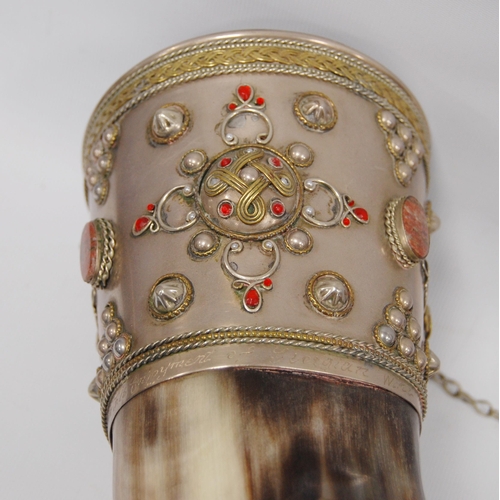 295 - Buffalo horn drinking cup, possibly of Russian origin, with white metal pommel and mount to one end ... 