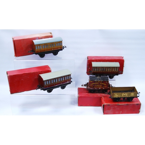 277 - Five Hornby by Meccano O gauge coaches and wagons comprising two French Voiture no. 1 coaches, 3113,... 