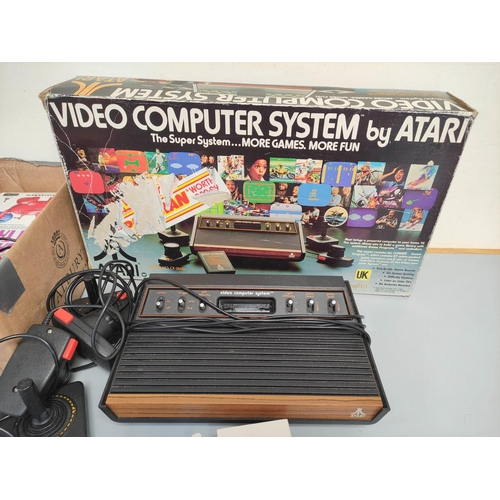 136 - Boxed Atari video computer system, model CX-2600A with accessories and games to include Missile Comm... 