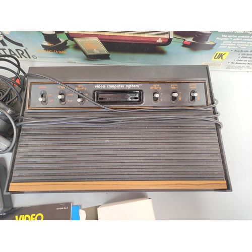 136 - Boxed Atari video computer system, model CX-2600A with accessories and games to include Missile Comm... 