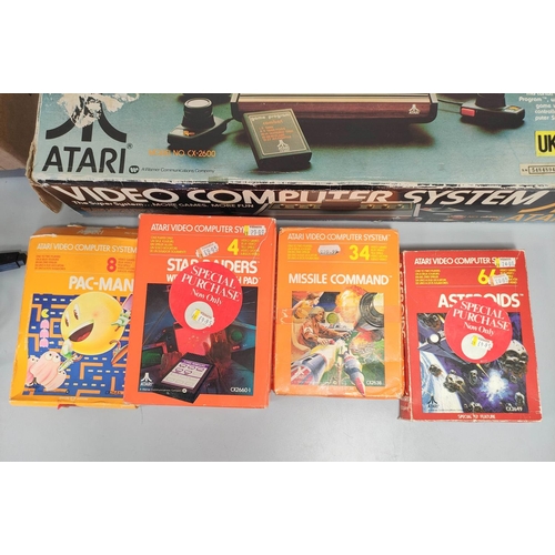 136 - Boxed Atari video computer system, model CX-2600A with accessories and games to include Missile Comm... 