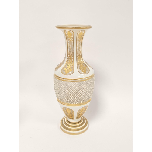 414 - Bohemian yellow and white overlaid glass vase, circa early 20th century, with dimple cut slender nec... 