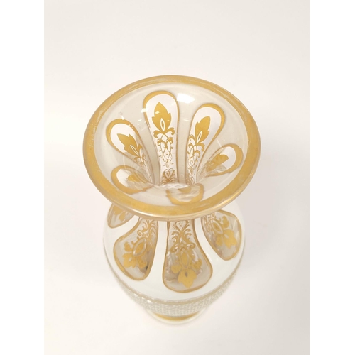 414 - Bohemian yellow and white overlaid glass vase, circa early 20th century, with dimple cut slender nec... 