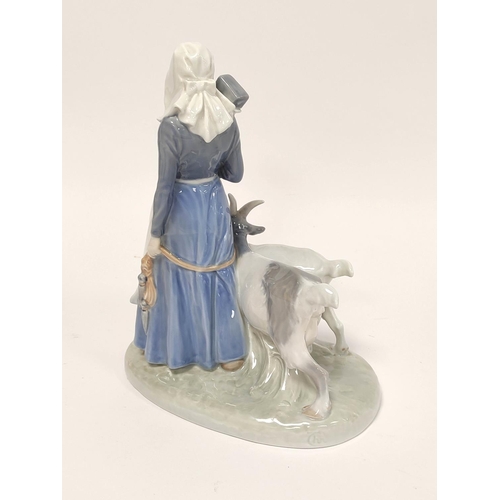 343 - Royal Copenhagen porcelain figure group of a farming girl with two goats on a shaped base, backstamp... 