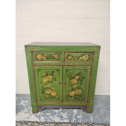 495 - Indian style green painted and lacquered decoupage cupboard with two small drawers above cupboard ba... 