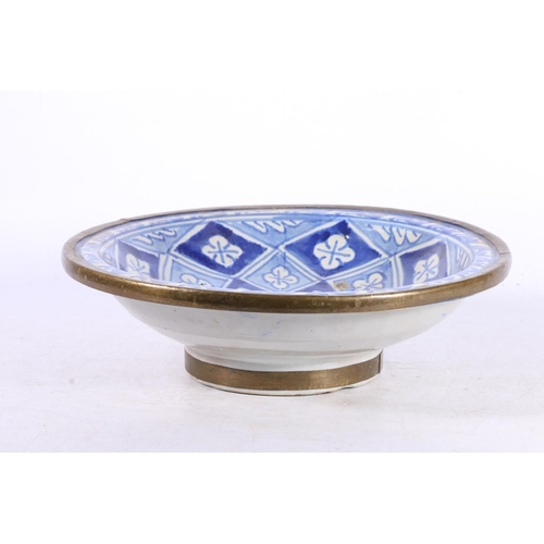 105 - Middle Eastern Iznik style blue and white ceramic bowl with pewter rim, 25.5cm wide.