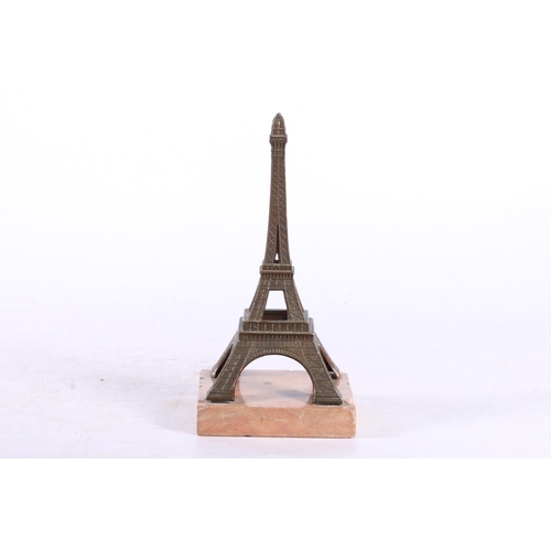 107 - Early 20th century souvenir model of the Eiffel Tower of bronzed metal on a marble base, 19cm high.