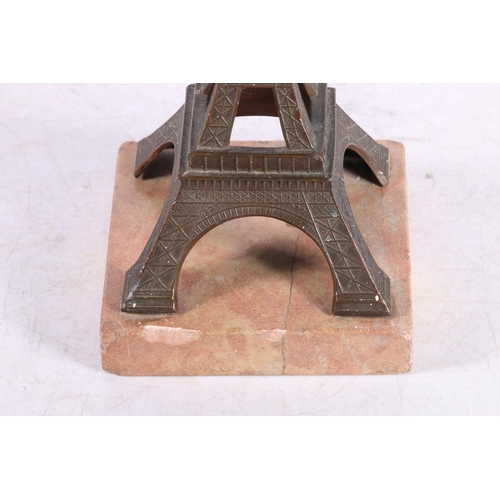 107 - Early 20th century souvenir model of the Eiffel Tower of bronzed metal on a marble base, 19cm high.