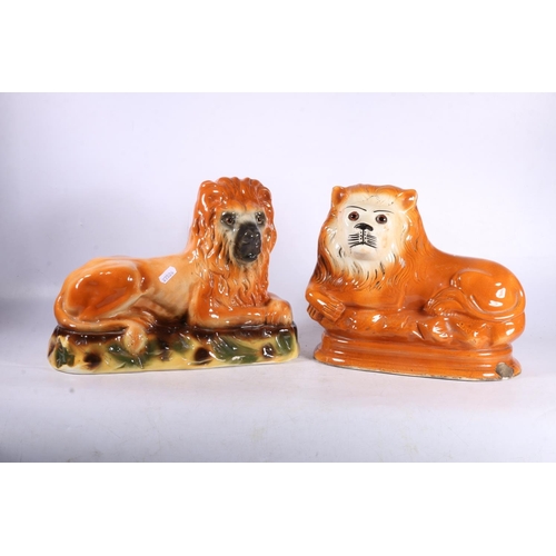 126 - Two Victorian Staffordshire fireside models of lions, 26cm high.