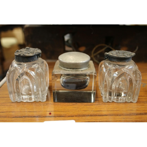 172 - Pair of moulded glass inkwells with white metal tops, and another.