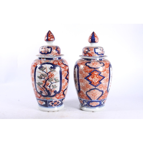 189 - Pair of oriental Imari baluster temple jars and covers, 30cm high.