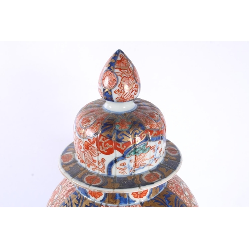 190 - Oriental pumpkin shaped baluster Imari temple jar and cover, 30cm high.