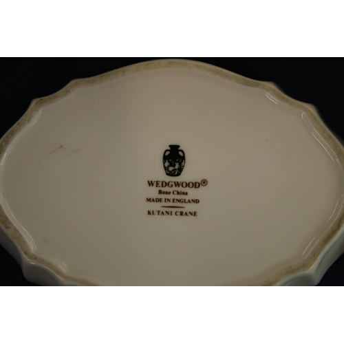 201 - Wedgwood Kutani Crane dinner and tea service comprising soup coupes and stands, cups and saucers, di... 