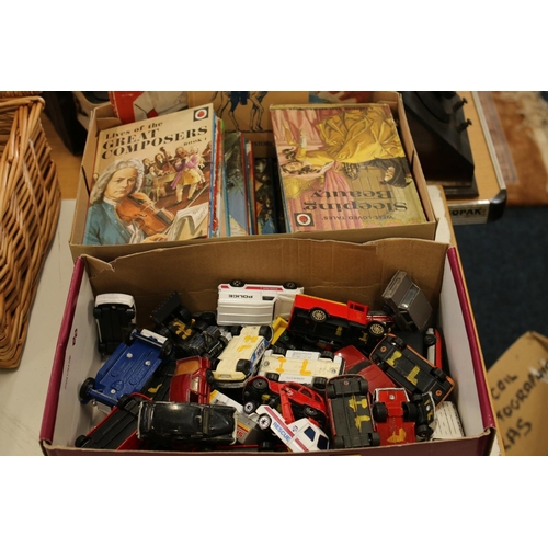 213 - Die-cast playworn vehicles and a box containing Ladybird books.