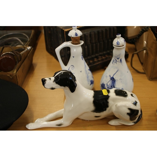 216 - Unmarked figurine of a setter in the style of Lomonosov, and two Dutch blue and white Delft bottle v... 