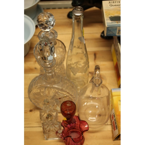 245 - Glassware to include decanters, a bottle, etc.