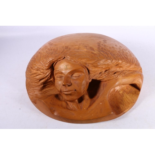 80 - Wooden wall plaque carved in the form of an earth goddess, 34cm wide.