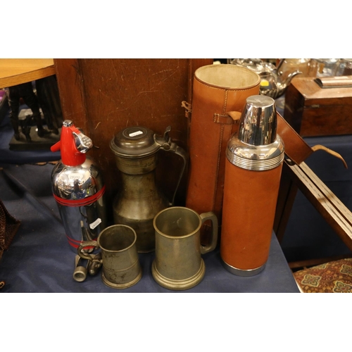 92 - 19th century pewter flagon with hinged lid, two pewter tankards, a soda syphon, etc.