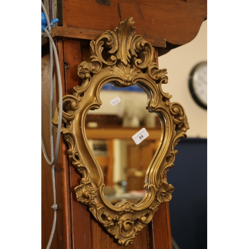 94 - Gilt framed Rococo style mirror, 49cm high.