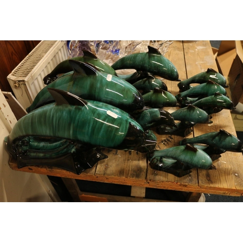 96 - Green slip glaze pottery dolphins.