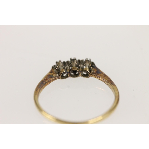 504 - c1920s three stone diamond ring, the round cut diamonds set on platinum mount on a 18ct gold shank, ... 