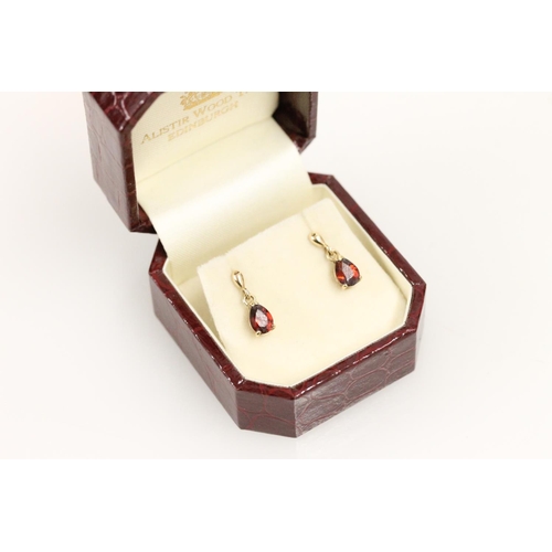 508 - Pair of 9ct gold and pear cut red stone earrings, 1.3g