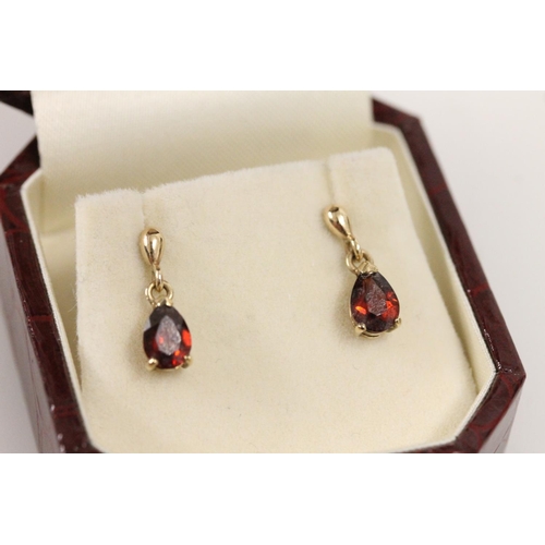 508 - Pair of 9ct gold and pear cut red stone earrings, 1.3g