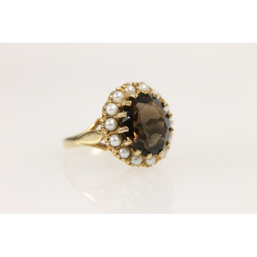 510 - 9ct gold and smoky quartz cluster ring, the oval cut stone surrounded by a halo of split pearls, siz... 