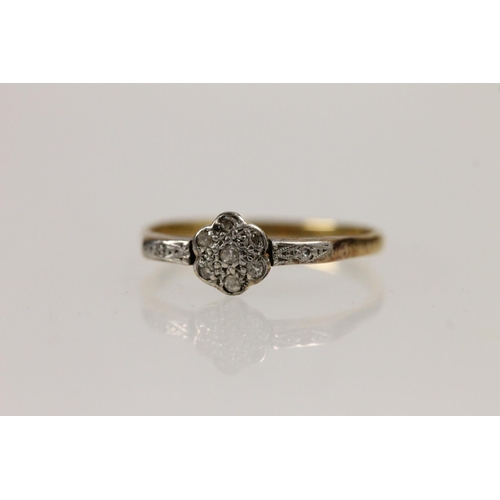 517 - 18ct gold and diamond daisy ring, the chip diamonds mounted on platinum setting, size O, 1.9g