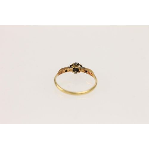 517 - 18ct gold and diamond daisy ring, the chip diamonds mounted on platinum setting, size O, 1.9g