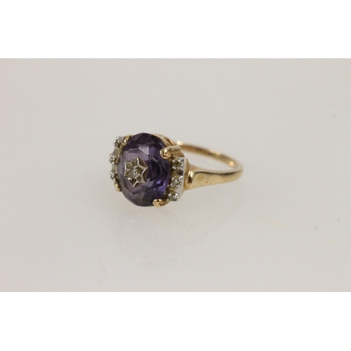 530 - 14ct gold ring, set with central amethyst studded with diamond in star setting and small diamonds fl... 