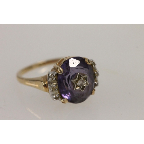 530 - 14ct gold ring, set with central amethyst studded with diamond in star setting and small diamonds fl... 