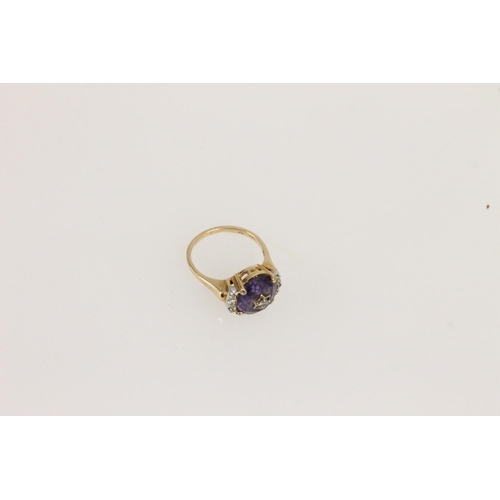 530 - 14ct gold ring, set with central amethyst studded with diamond in star setting and small diamonds fl... 