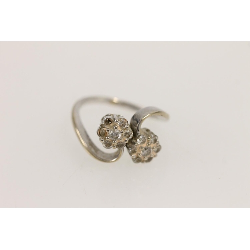 531 - 18ct white gold ring set with two diamond clusters in a daisy setting (missing two stones), size P/Q... 