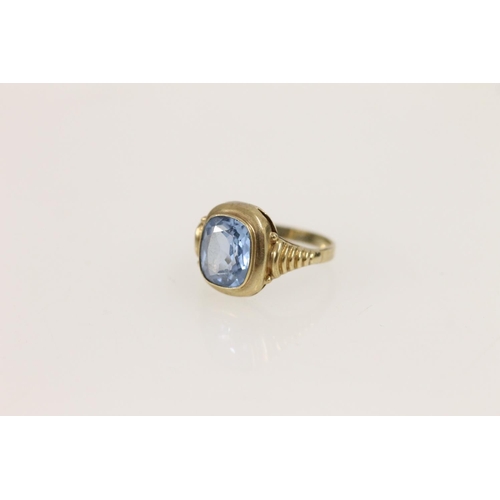 533 - Yellow metal ring (hallmark indistinct) set with cushion cut aquamarine/blue zircon, size O, 2.5g